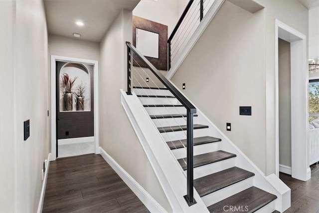 stairway with hardwood / wood-style floors