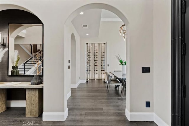 foyer with dark hardwood / wood-style flooring and crown molding