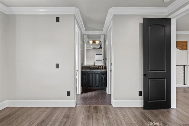 hall featuring ornamental molding and hardwood / wood-style floors