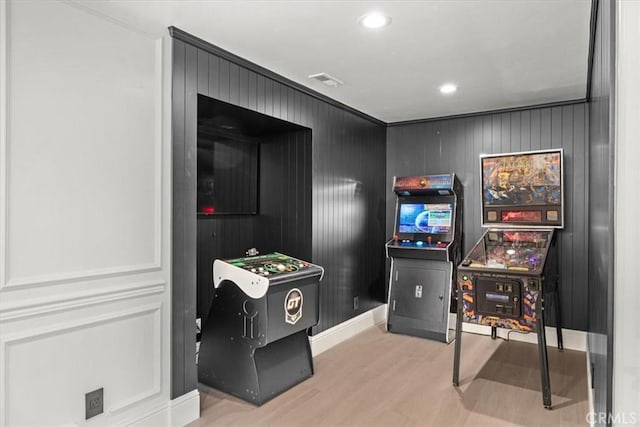 game room with light hardwood / wood-style flooring