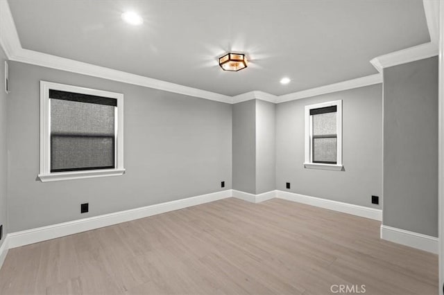 empty room with light hardwood / wood-style floors and ornamental molding