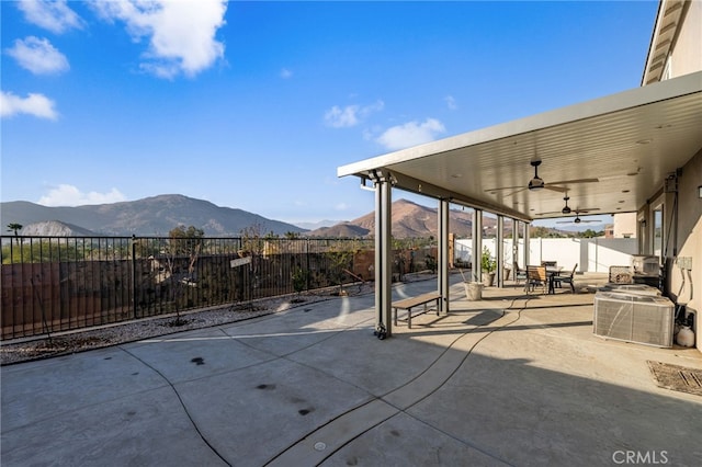 view of patio / terrace featuring ceiling fan and a mountain view