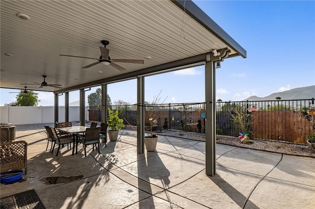 view of patio / terrace featuring ceiling fan and a mountain view