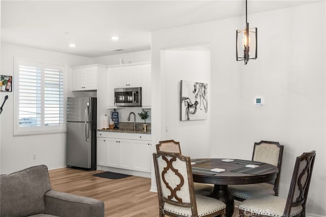 dining room with sink and light hardwood / wood-style floors