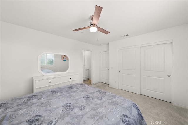 unfurnished bedroom with ceiling fan, light colored carpet, and a closet