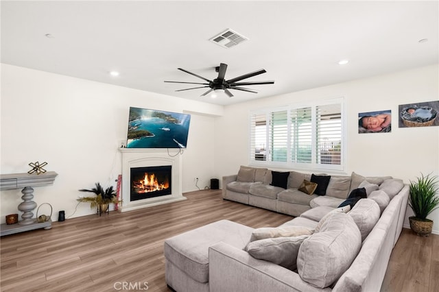 living room featuring hardwood / wood-style flooring and ceiling fan