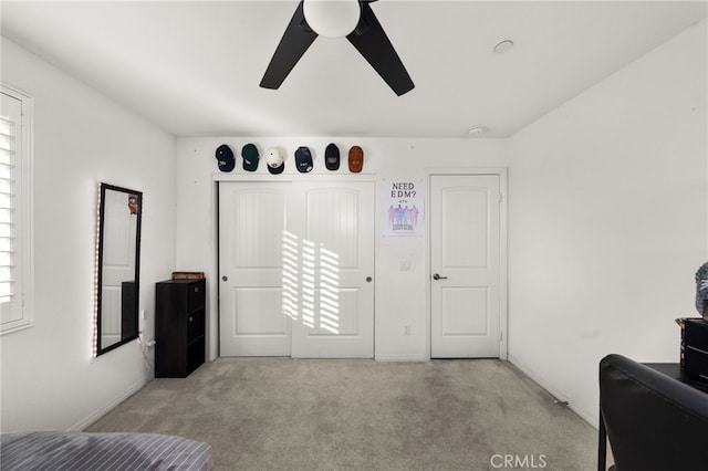 carpeted bedroom featuring ceiling fan and multiple windows