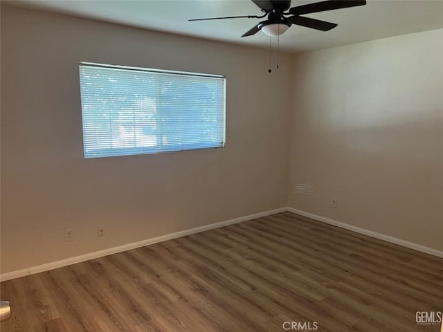 unfurnished room featuring ceiling fan and dark hardwood / wood-style flooring