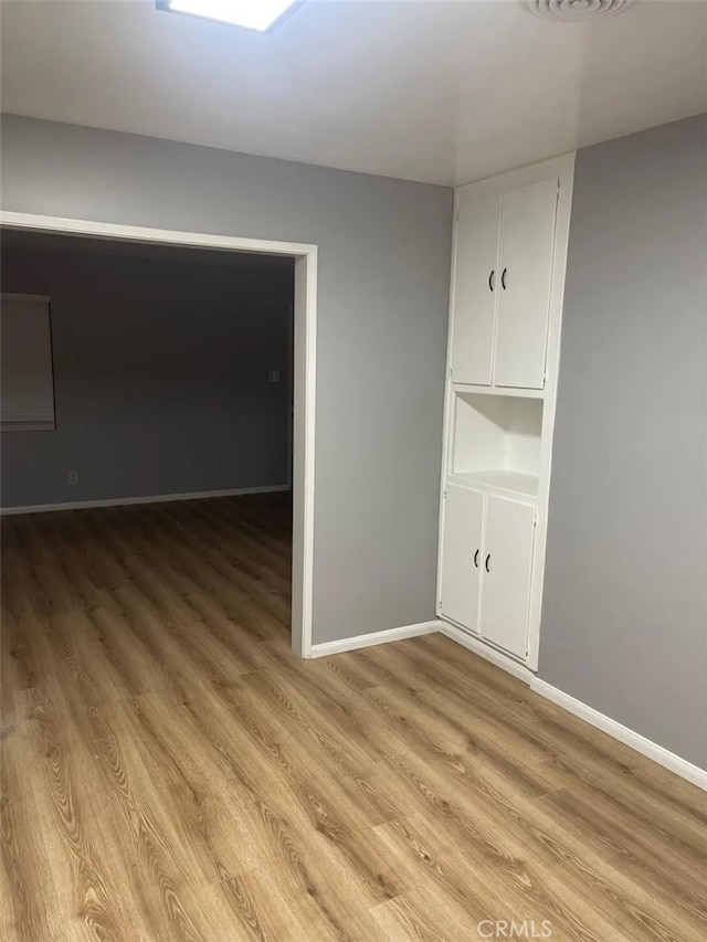 spare room featuring light hardwood / wood-style flooring