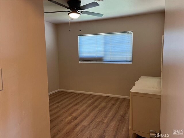 unfurnished room featuring ceiling fan and wood-type flooring