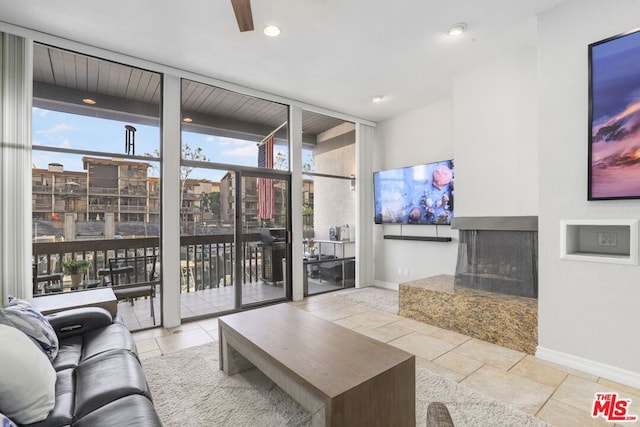 living room featuring floor to ceiling windows and light tile patterned floors