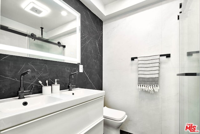 bathroom with toilet, walk in shower, tasteful backsplash, and vanity