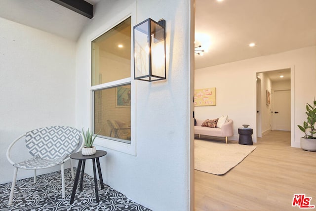 hall with lofted ceiling with beams and hardwood / wood-style flooring