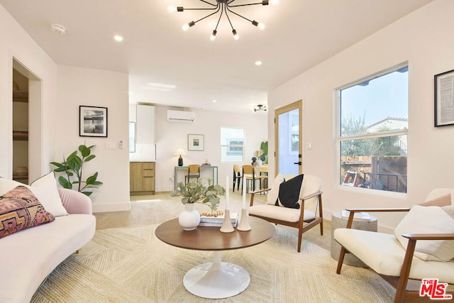 living room featuring a wall unit AC and a chandelier