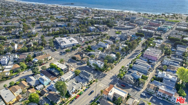 birds eye view of property with a beach view and a water view