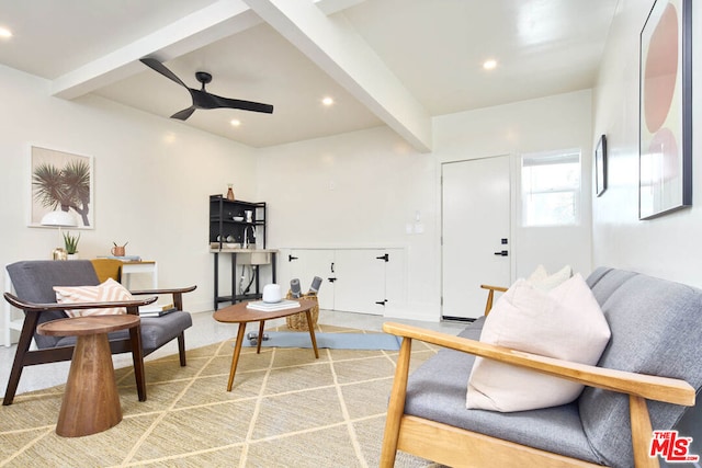 sitting room featuring ceiling fan and beamed ceiling