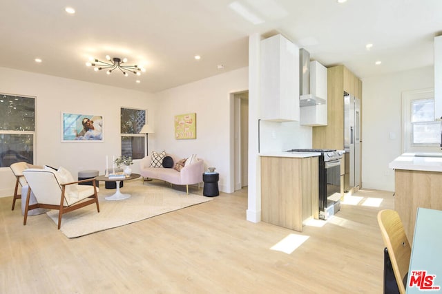 living room with light wood-type flooring and an inviting chandelier