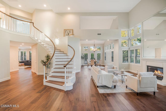 living room featuring a high ceiling and dark hardwood / wood-style floors