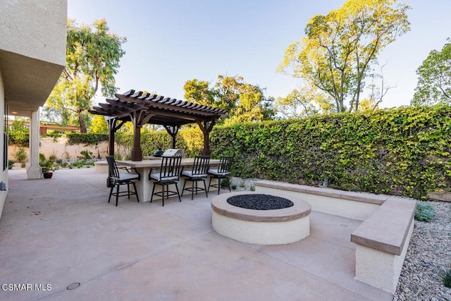 view of patio / terrace featuring a pergola, a bar, and a fire pit