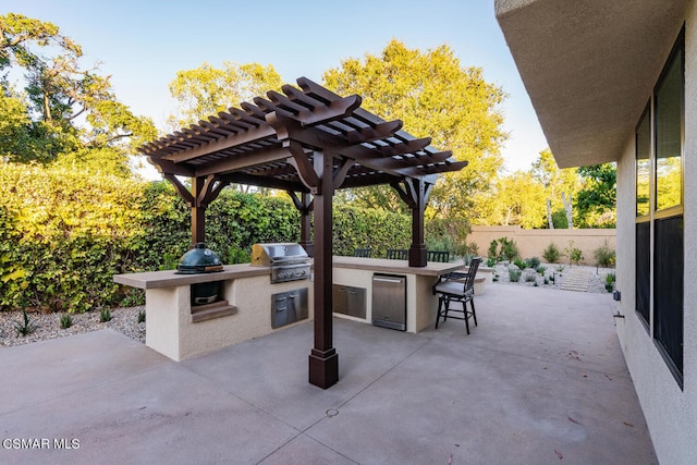 view of patio / terrace with a pergola, a grill, a bar, and exterior kitchen