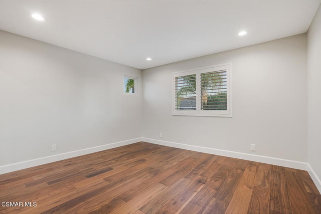 unfurnished room with wood-type flooring