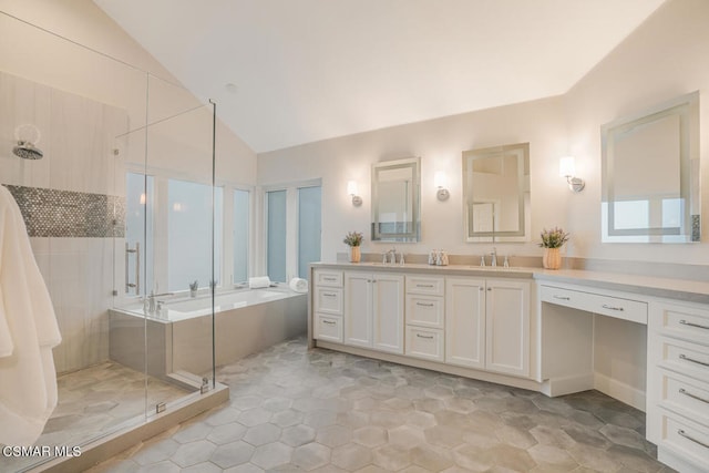 bathroom with independent shower and bath, lofted ceiling, and vanity