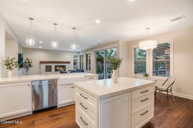 kitchen with pendant lighting, a kitchen island, sink, dark hardwood / wood-style floors, and stainless steel dishwasher