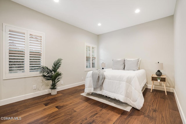 bedroom with dark wood-type flooring