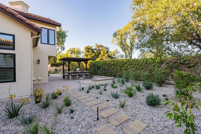 view of yard featuring a patio area, exterior bar, and a pergola