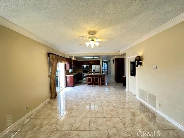 interior space with a textured ceiling, ceiling fan, and ornamental molding