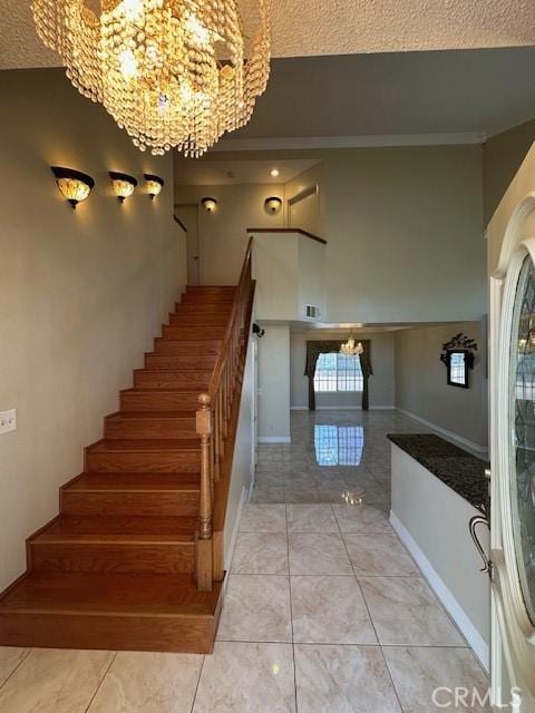 stairs featuring a chandelier and tile patterned floors