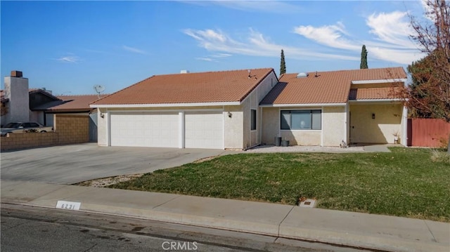 ranch-style home featuring a front lawn and a garage