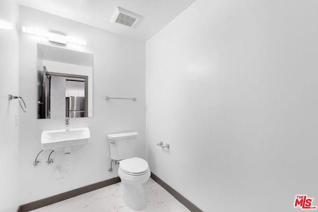 bathroom with toilet and sink