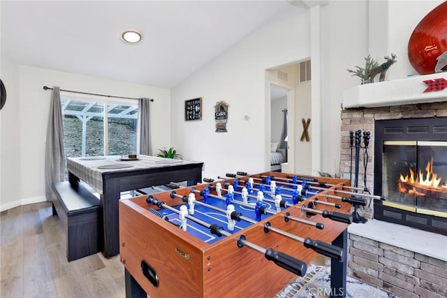 rec room featuring vaulted ceiling and hardwood / wood-style floors