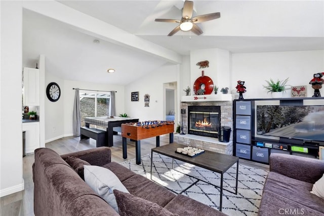 living room featuring ceiling fan, vaulted ceiling with beams, and light hardwood / wood-style floors