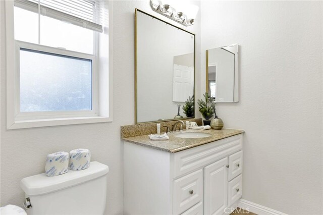 bathroom with toilet and vanity