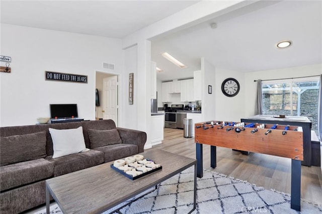 recreation room featuring light hardwood / wood-style flooring