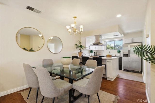 dining room with dark hardwood / wood-style flooring and a chandelier