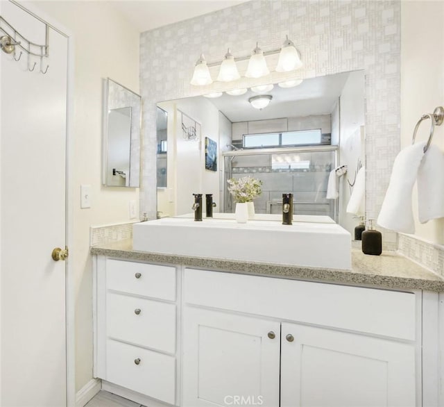 bathroom featuring an enclosed shower and vanity