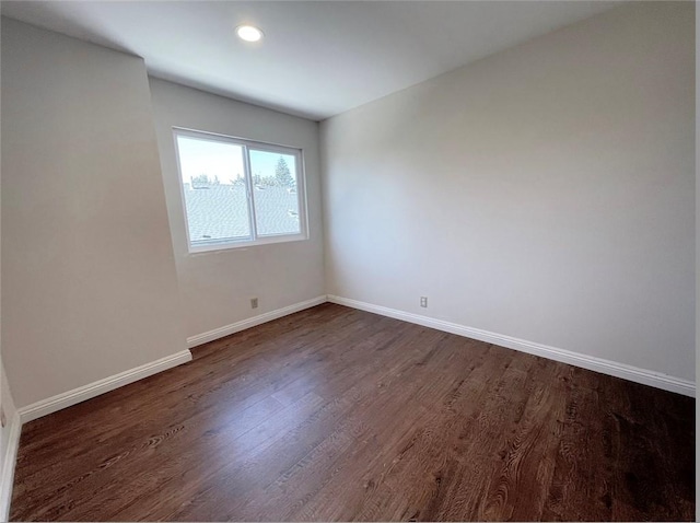 unfurnished room featuring dark hardwood / wood-style flooring