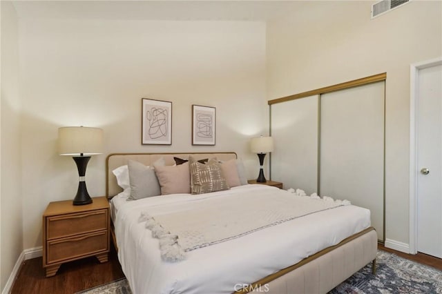 bedroom with a closet and dark hardwood / wood-style flooring