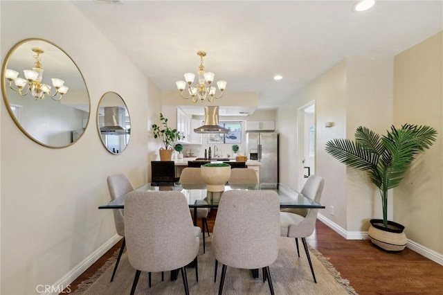 dining space featuring a chandelier, wood-type flooring, and sink