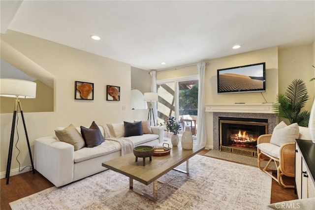 living room with a premium fireplace and hardwood / wood-style flooring