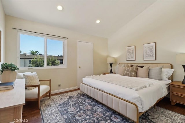 bedroom with vaulted ceiling and dark hardwood / wood-style floors