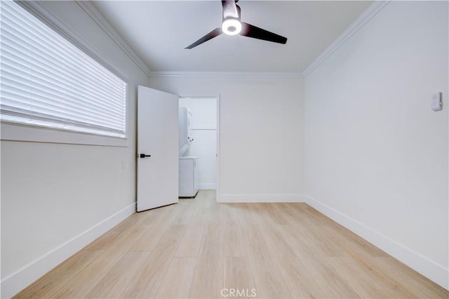 empty room featuring ceiling fan, ornamental molding, and light wood-type flooring