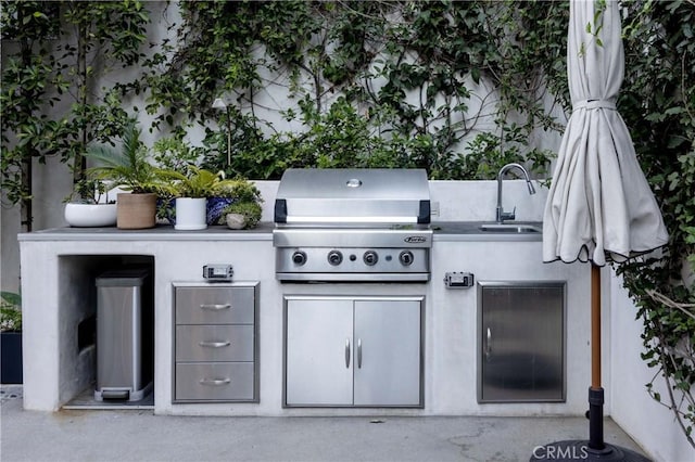 view of patio / terrace with grilling area, an outdoor kitchen, and sink