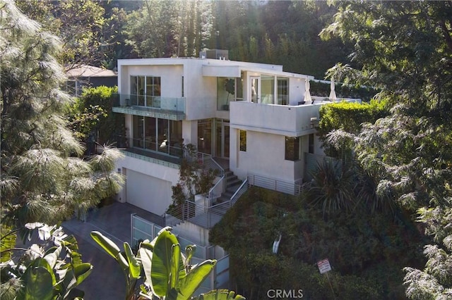 view of front of house featuring a garage and a balcony