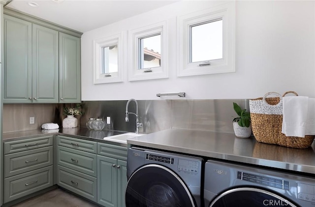 laundry room featuring cabinets, sink, and washing machine and dryer