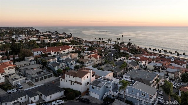 aerial view at dusk with a water view