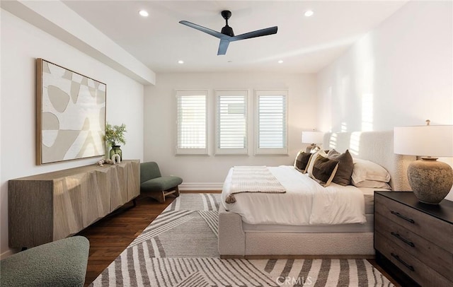 bedroom with ceiling fan and dark hardwood / wood-style flooring